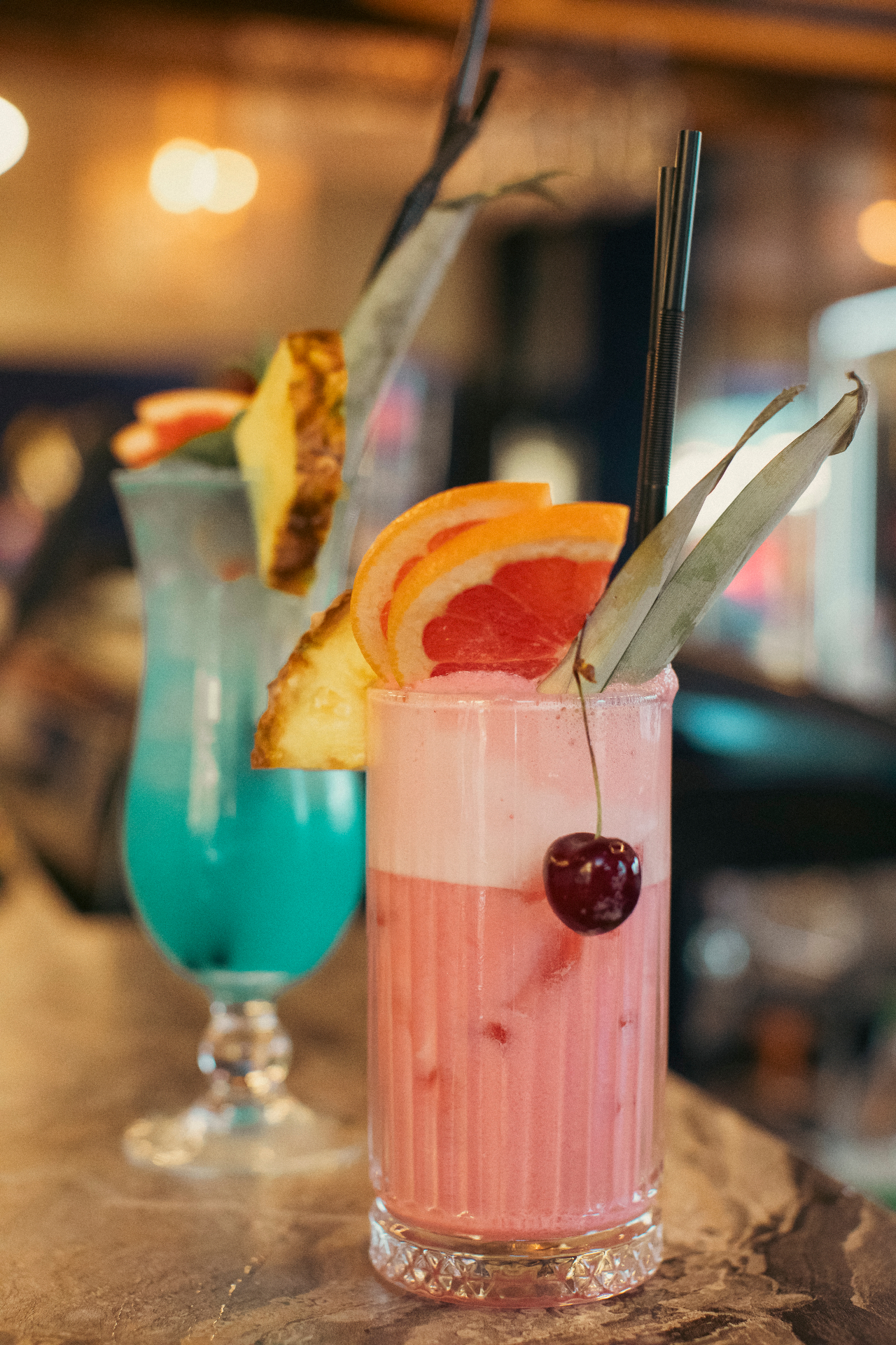 Pink and blue signature drinks served on the bar