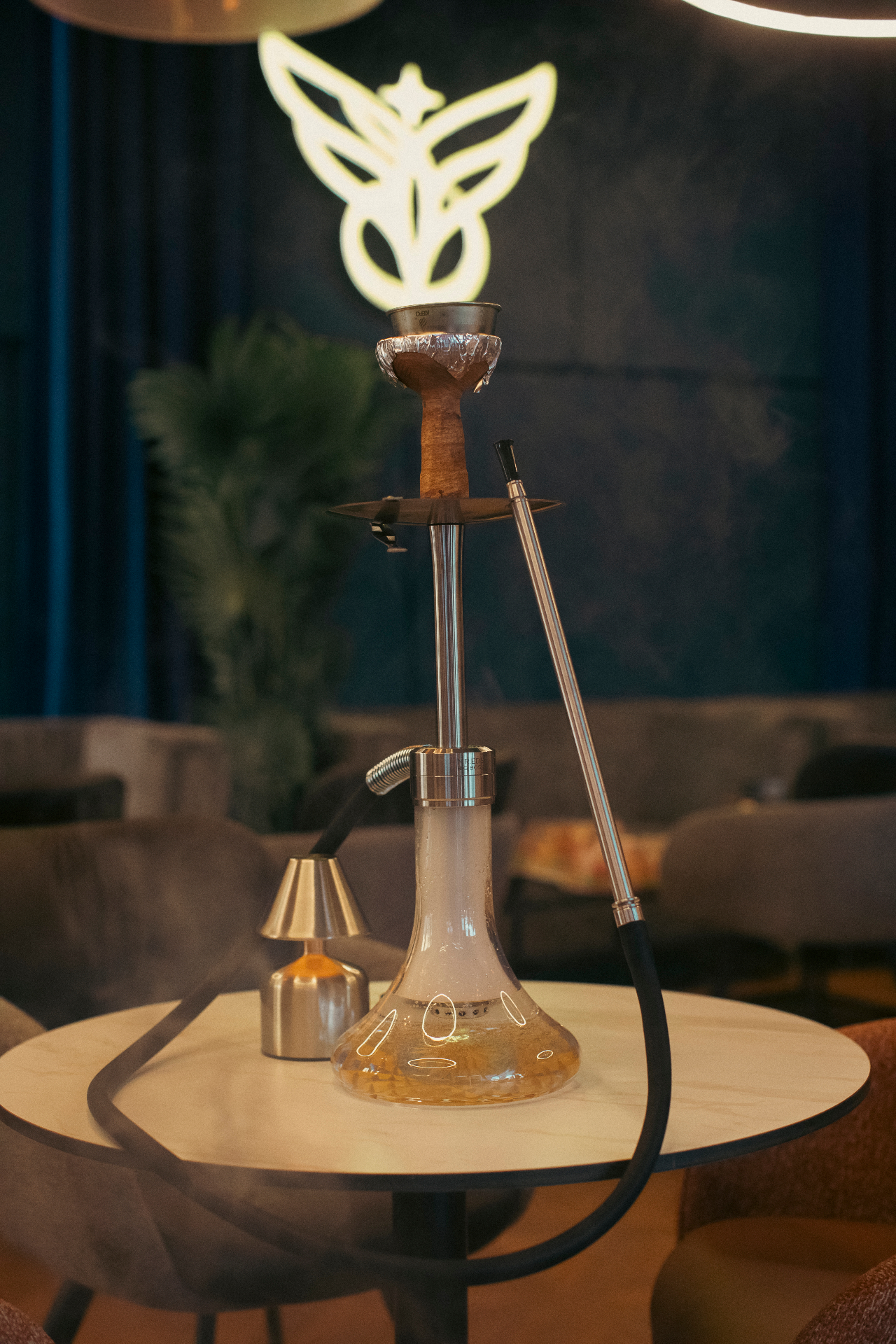Shisha set in front of the glowing Camara butterfly logo